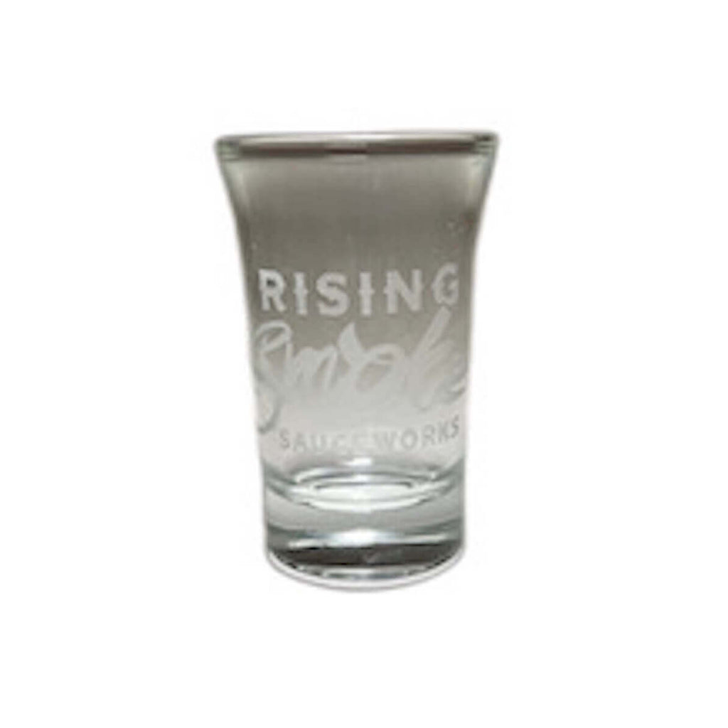 Shot glass with Rising Smoke Sauceworks etched in the glass.