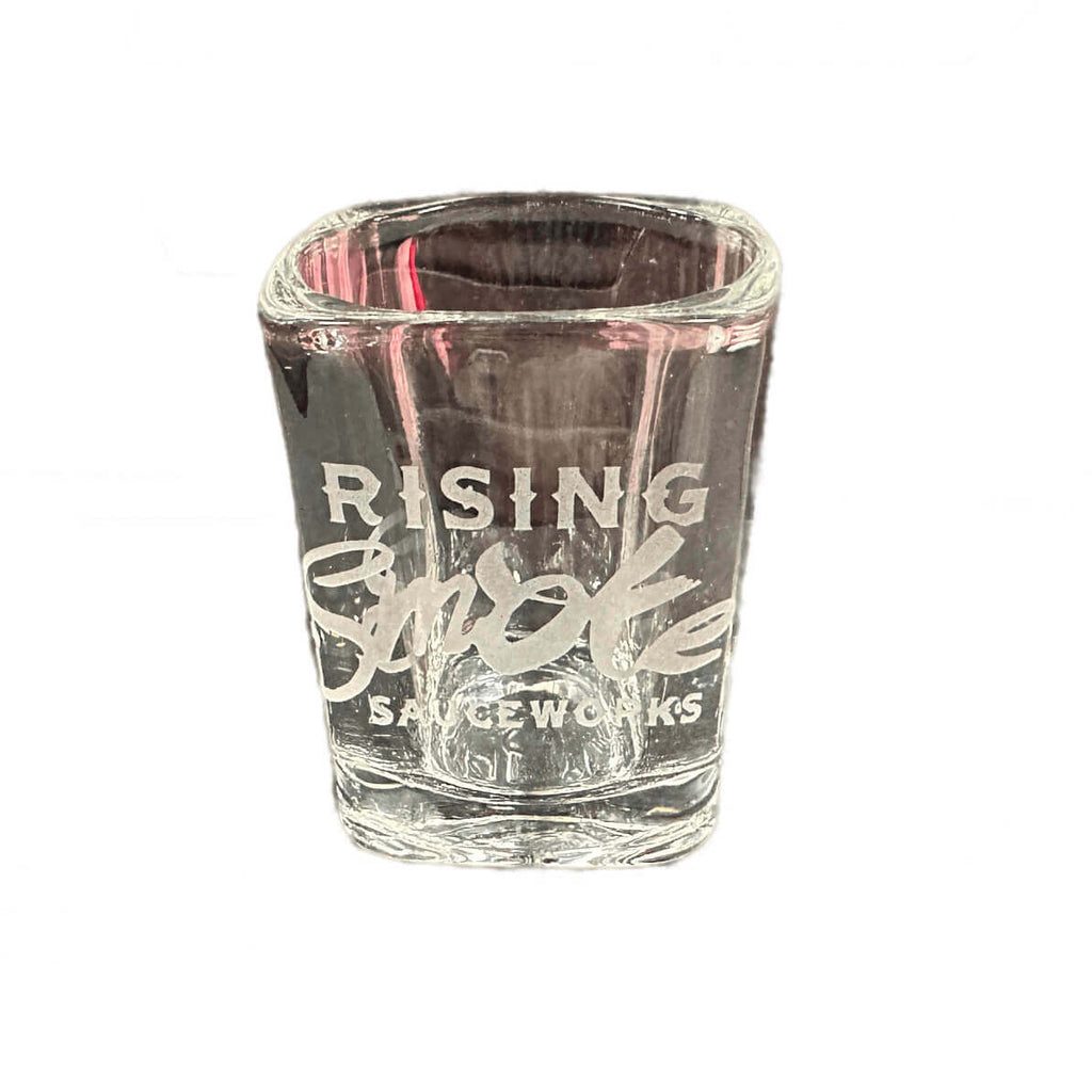 Shot glass with Rising Smoke Sauceworks etched in the glass.